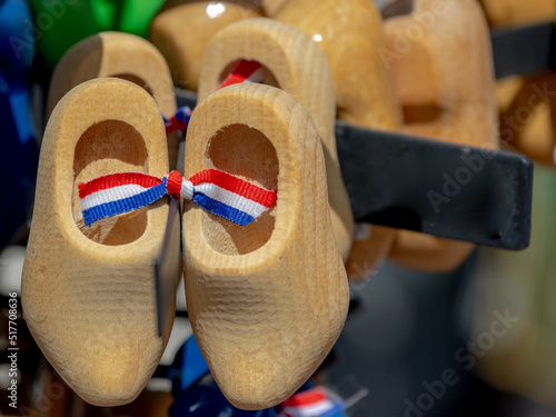 Business concept, Selective focus of wooden shoe with National flag of Netherlands (red,white,blue colour) display on souvenir shop, Clogs are a type of footwear made in part or completely from wood.
