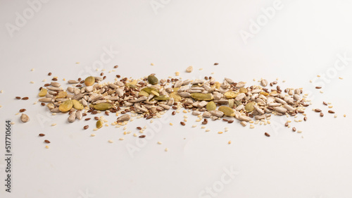 Mix of seeds for a salad. A pile of mixed seeds isolated on white background.