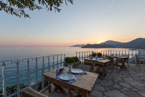 Beautiful place art the coast of Mediterranean Sea for relaxation at summer time. Tables of the restaurant ready to eat © ern