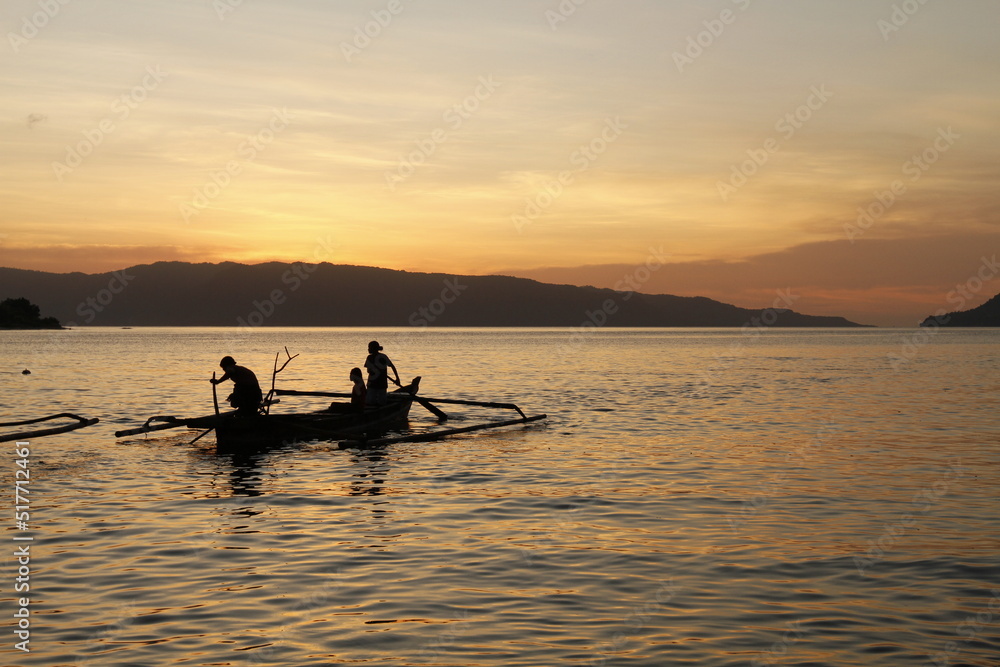 silhouette of a person in a boat