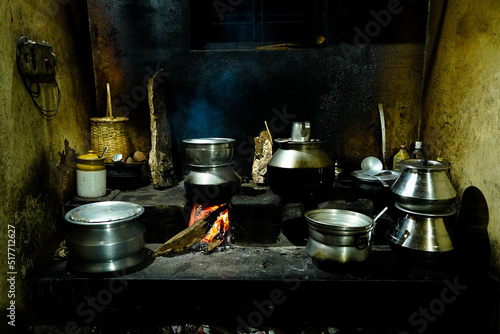 Food is prepared in an old village kitchen with firewood  in Kerala