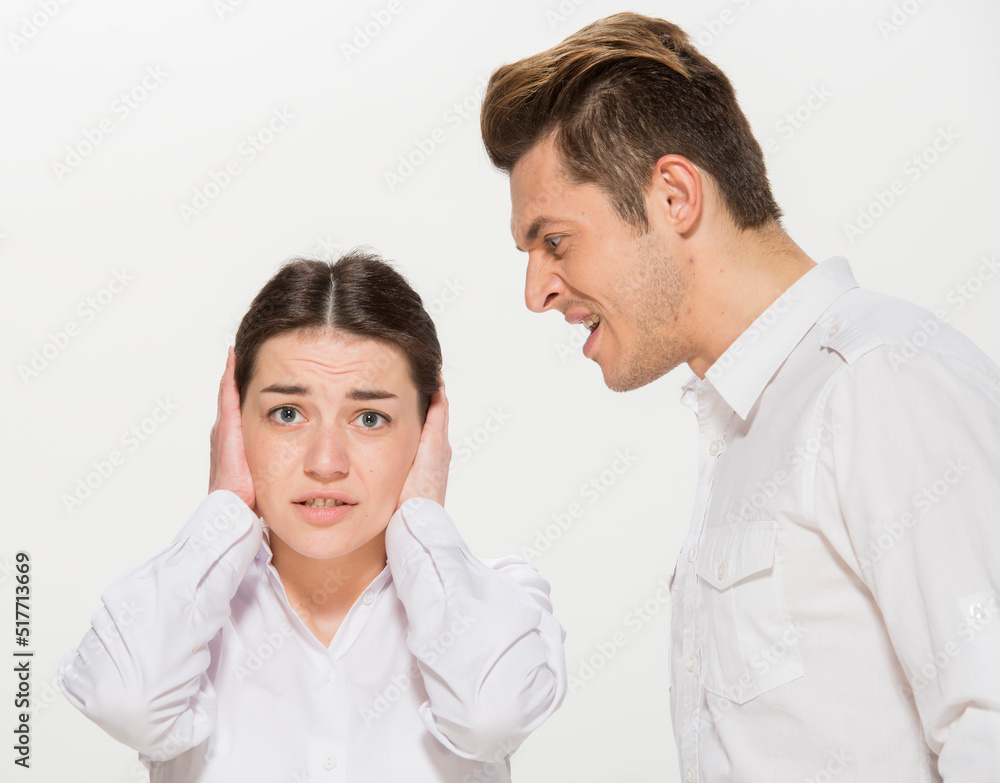 the boss scolds the young subordinate.close-up portrait of two workers on a white background isolated.the man yells at the girl.teaches the girl.points out the mistakes. the boss scolds the young subordinate.close-up portrait of two workers on a white background isolated.the man yells at the girl.teaches the girl.points out the mistakes.