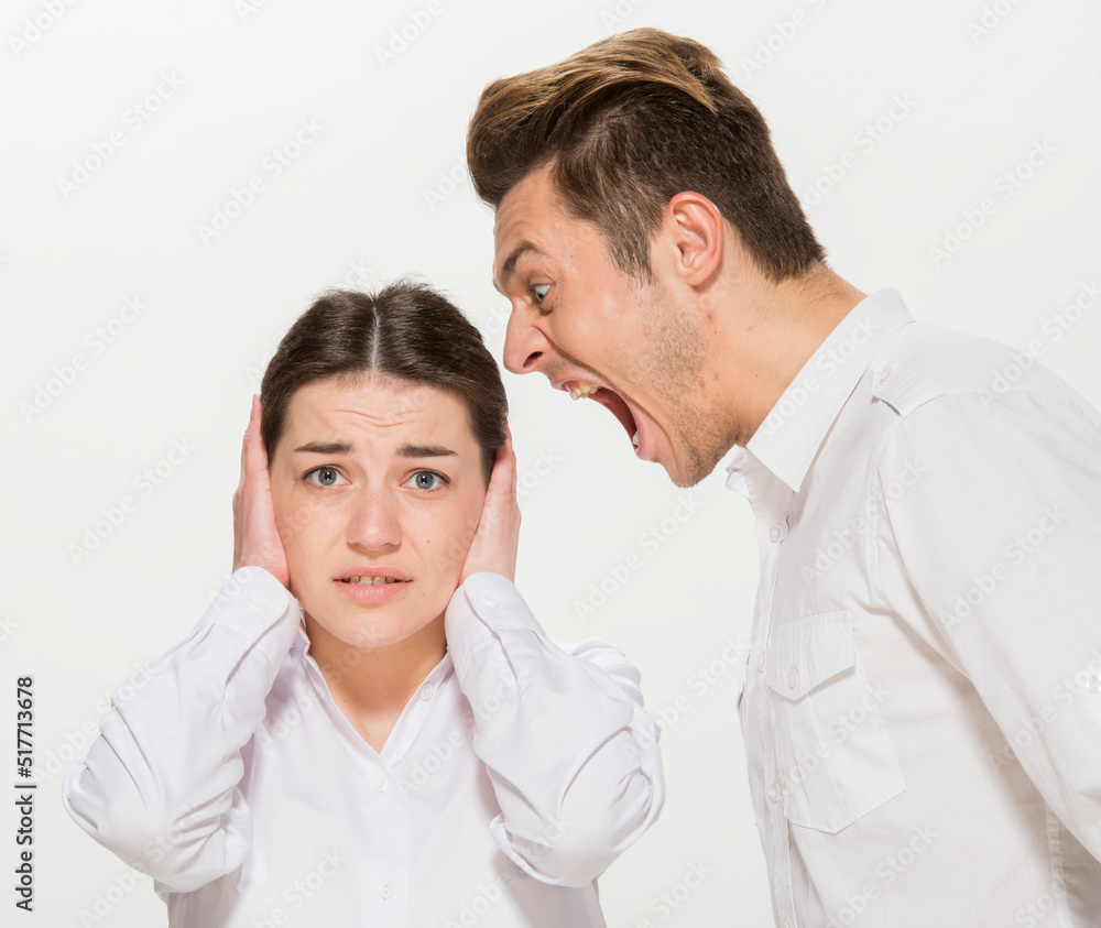 the boss scolds the young subordinate.close-up portrait of two workers on a white background isolated.the man yells at the girl.teaches the girl.points out the mistakes. the boss scolds the young subordinate.close-up portrait of two workers on a white background isolated.the man yells at the girl.teaches the girl.points out the mistakes.