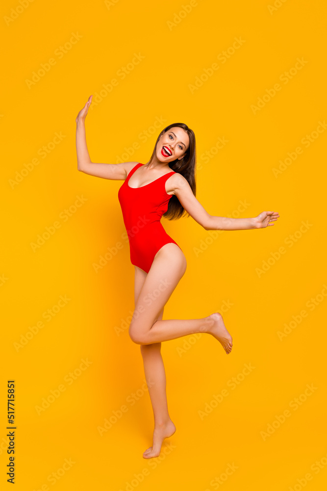 Full length vertical portrait of charming carefree girl enjoy dancing isolated on yellow color background Full length vertical portrait of charming carefree girl enjoy dancing isolated on yellow color background