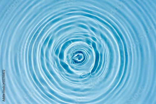 Texture of blue water with rings and ripples from drops