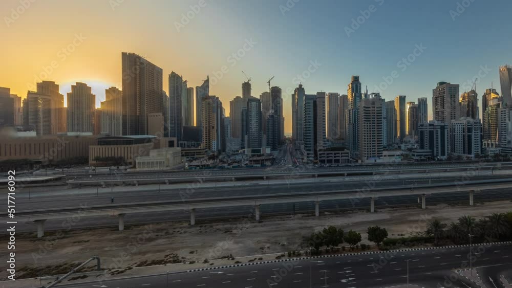 Panorama of Dubai marina tallest block of skyscrapers evening timelapse during sunset. Aerial view from JLT district to apartment buildings, hotels and office towers near highway. Panorama of Dubai marina tallest block of skyscrapers evening timelapse during sunset. Aerial view from JLT district to apartment buildings, hotels and office towers near highway.