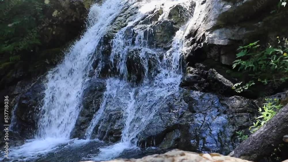 Beautiful forest waterfall with man standing on the side of it in the pine forest during summer. Northwest USA. Beautiful forest waterfall with man standing on the side of it in the pine forest during summer. Northwest USA.