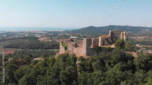 Fall in love with Spain.  Visit the Castell de Palafolls in the cultural heart of Barcelona, Cataluña, Spain.  The landscape comes into view as a drone orbits the castle and brings history to life. photo