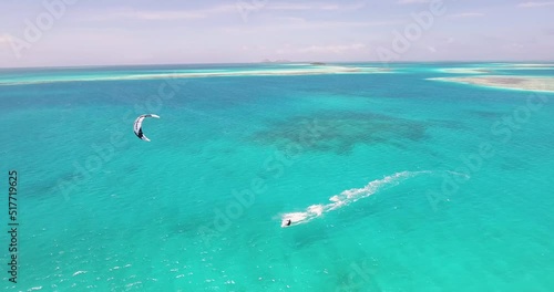 MAN KITESURFER sail on azure CARIBBEAN sea around SANDBAR, drone shot, LOS ROQUES photo