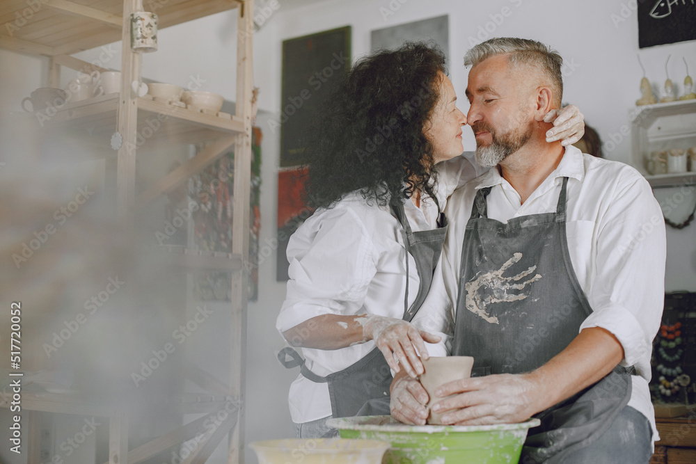 Adult senior couple at artwork in pottery