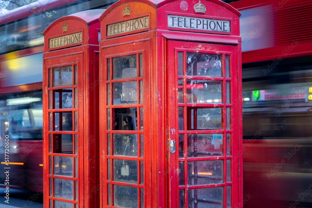 London red route master bus speeds past old British Red telephone boxes London red route master bus speeds past old British Red telephone boxes