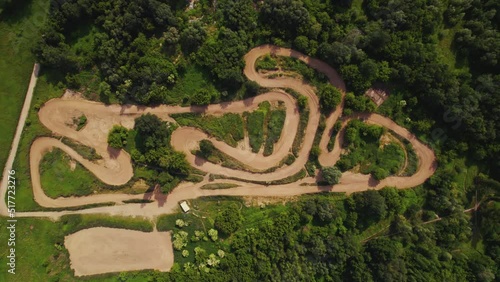 Motocross track in the middle oa greenf countryside. Horizontal drone shot. High quality 4k footage photo