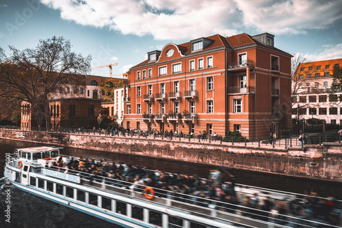 A tourist boat tour on the spree from Monbijou Bridge, Berlin, on a warm spring day photo