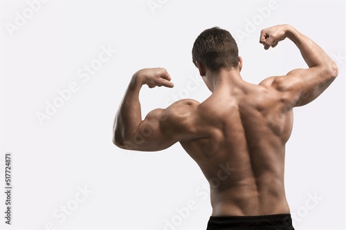 Workout and gym concept. Handsome man showing his muscles after sport exercises, flexing biceps