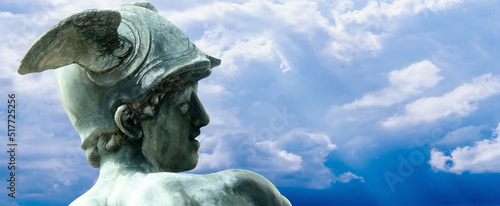 Fragment of na ancient statue of antique god of commerce, merchants, fraud and theft Hermes (Mercury). Copy space for design.