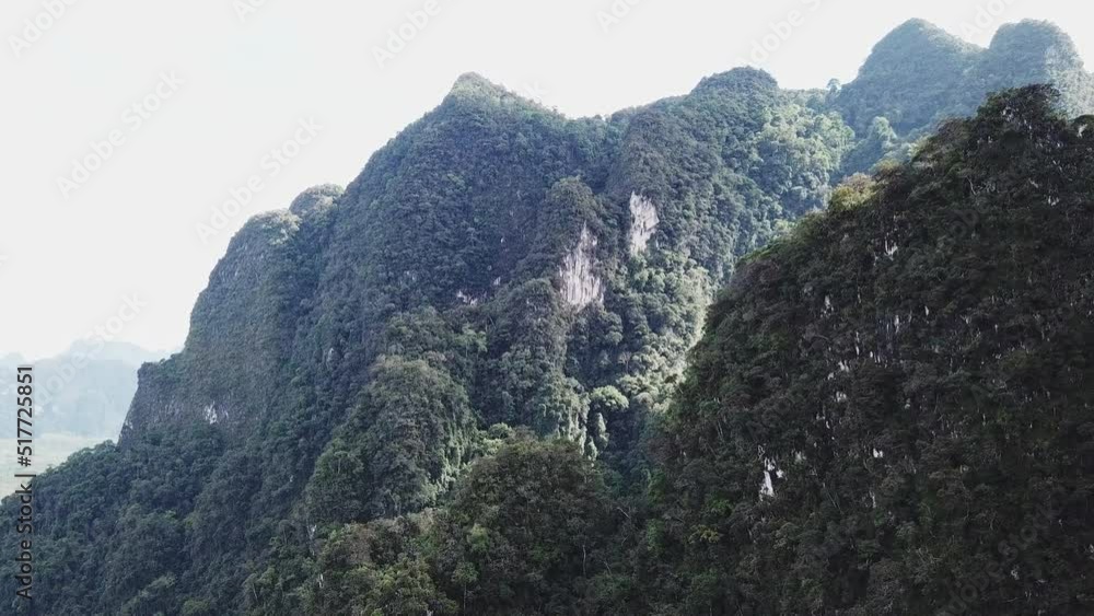 An aerial view of green mountains during the rain, in Thailand An aerial view of green mountains during the rain, in Thailand