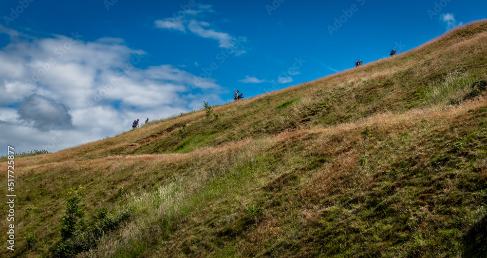 Walkers heading up British Camp, Malvern Hills, Worcestershire, UK.