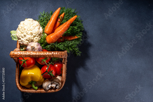 Autumn vegetables cooking background. Organic fall harvest farm vegetables, mushrooms. Various vegetarian ingredients set for cooking dinner on black kitchen background, top view copy space