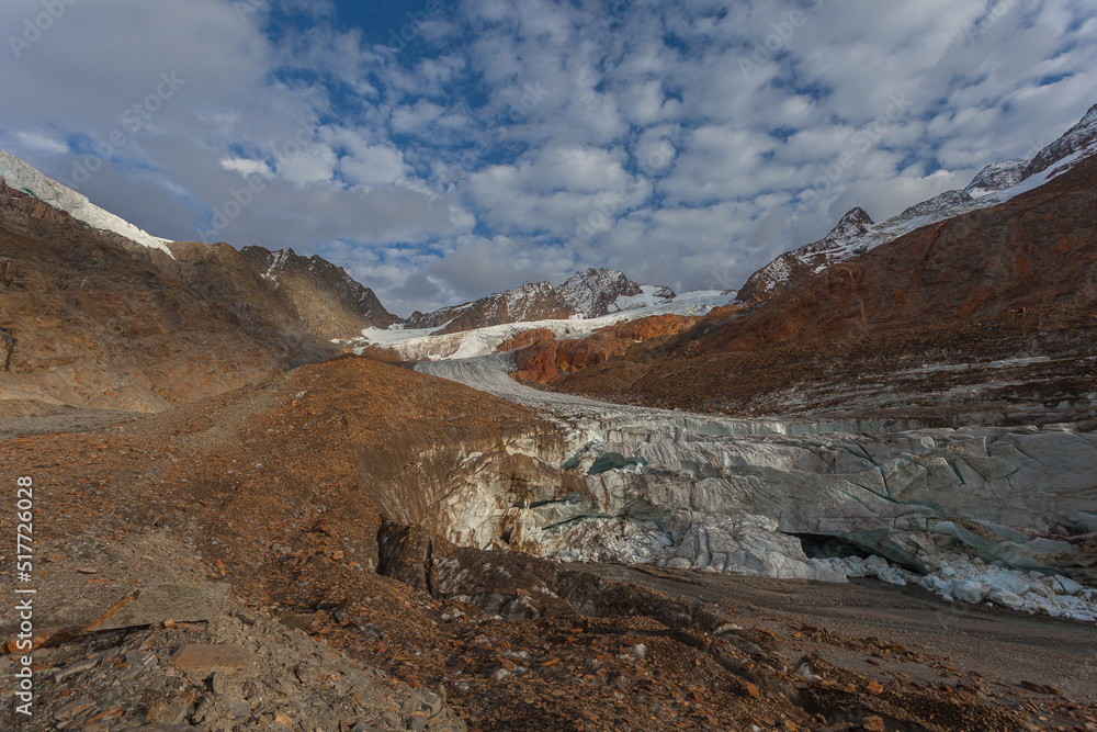Vallelunga Glacier tongue with collapsing front and ice caves from which a subglacial stream emerges. The glacier is in rapid retreat caused by global warming, Alto Adige, Italy Vallelunga Glacier tongue with collapsing front and ice caves from which a subglacial stream emerges. The glacier is in rapid retreat caused by global warming, Alto Adige, Italy