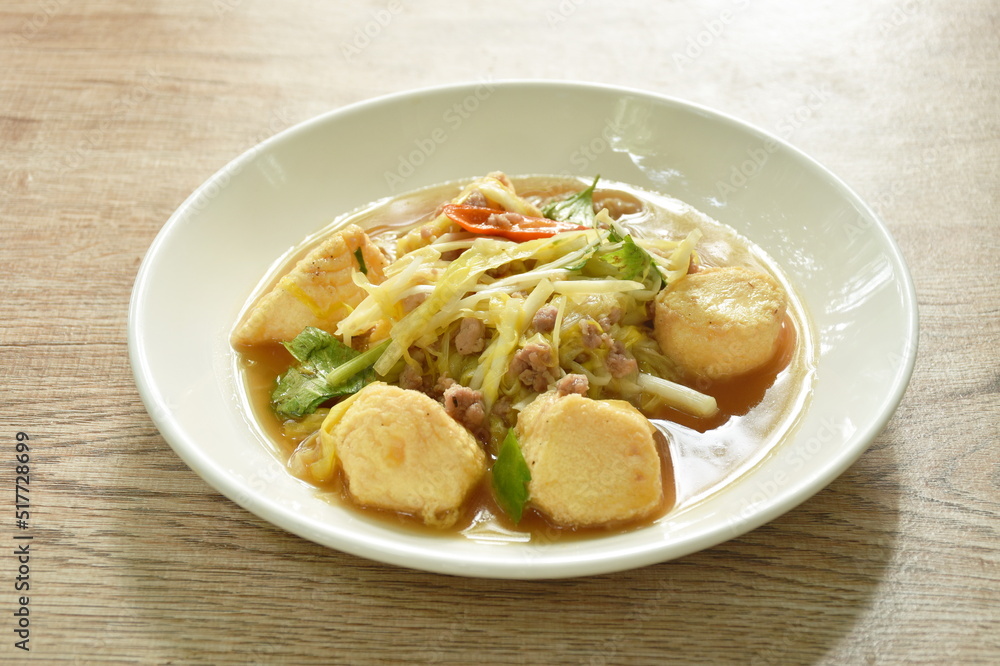 fried white garlic chive with slice yellow egg tofu and chop pork on plate