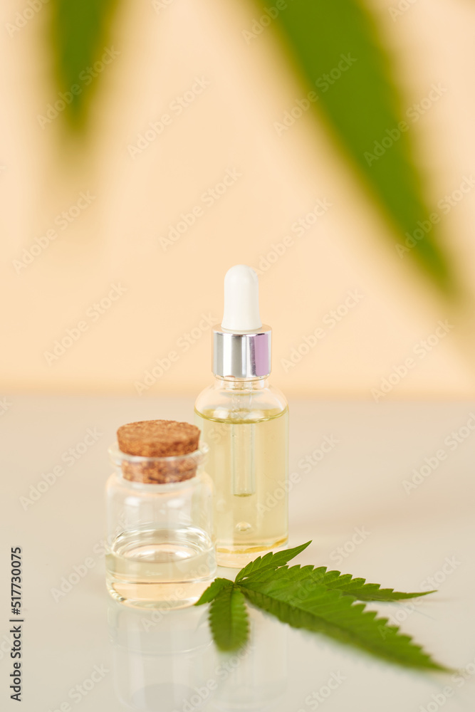 Cannabis essential oil. CBD oil extract in dropper bottle with cannabis green leaf Marijuana. Medical marijuana. Herbal medicine plant. Space for text. Cannabis essential oil. CBD oil extract in dropper bottle with cannabis green leaf Marijuana. Medical marijuana. Herbal medicine plant. Space for text.