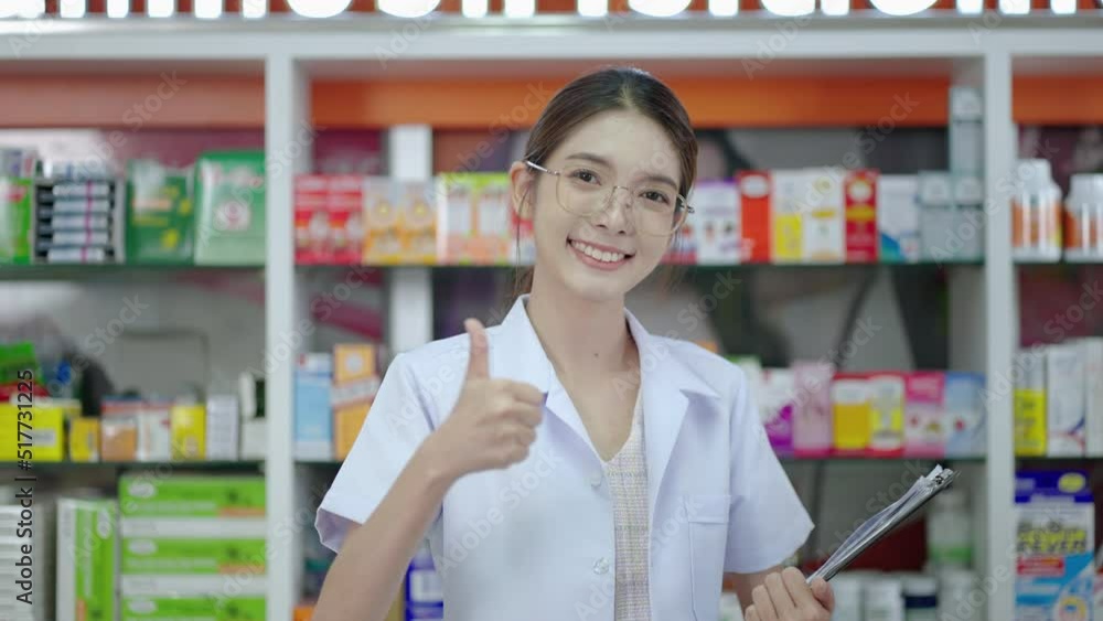 Beautiful Asian pharmacist standing with smiles and showing thumbs up in drugstore.Concept of maintaining health and confidence in service
Beautiful Asian pharmacist standing with smiles and showing thumbs up in drugstore.Concept of maintaining health and confidence in service