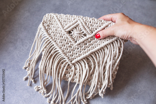 Handmade macrame cotton сross-body bag. Eco bag for women from cotton rope. Scandinavian style bag.  Bejge tones, sustainable fashion accessories. Details. Close up image photo