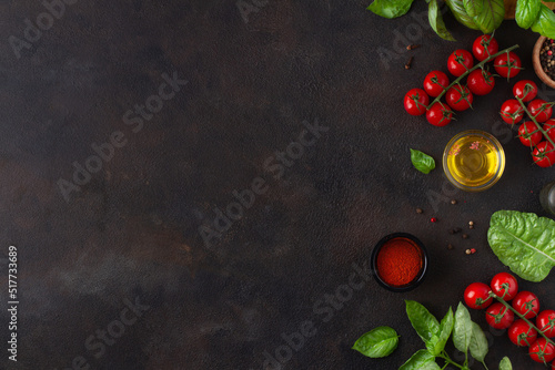 Dark background with tomatoes and basil