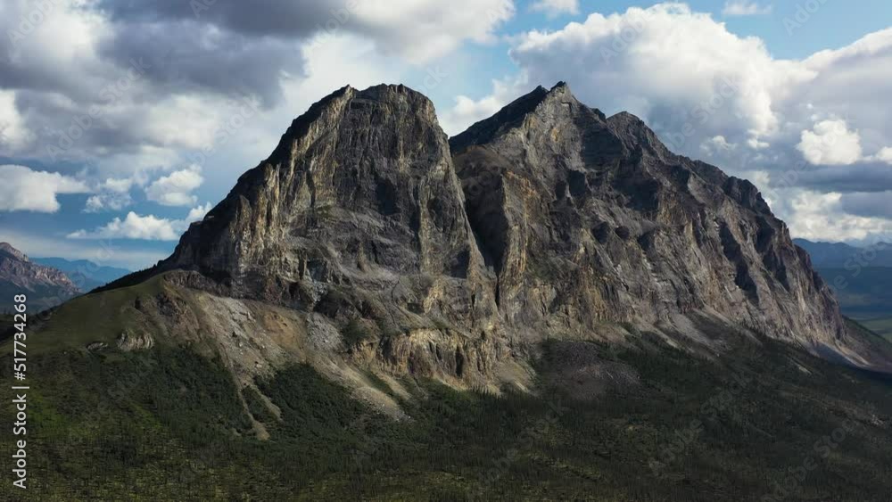 Flying Around Majestic Sukakpak Mountain against white clouds in summer Alaska Flying Around Majestic Sukakpak Mountain against white clouds in summer Alaska
