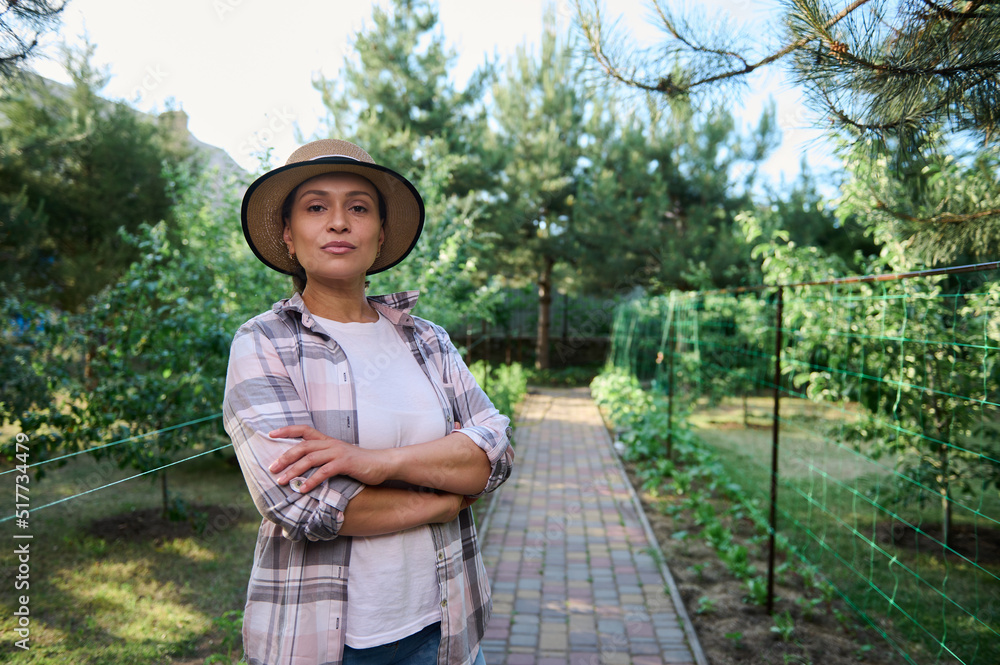 Portrait of a confident woman, farmer, gardener in an organic farm. Horticulturist, agricultural hobby, agribusiness. 