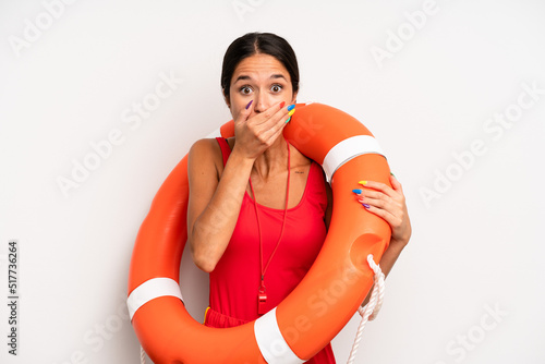 hispanic pretty woman covering mouth with hands with a shocked. lifeguard concept