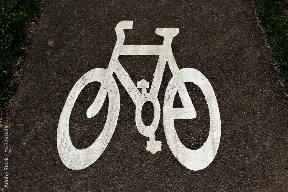 White bicycle lane sign on asphalt White bicycle lane sign on asphalt