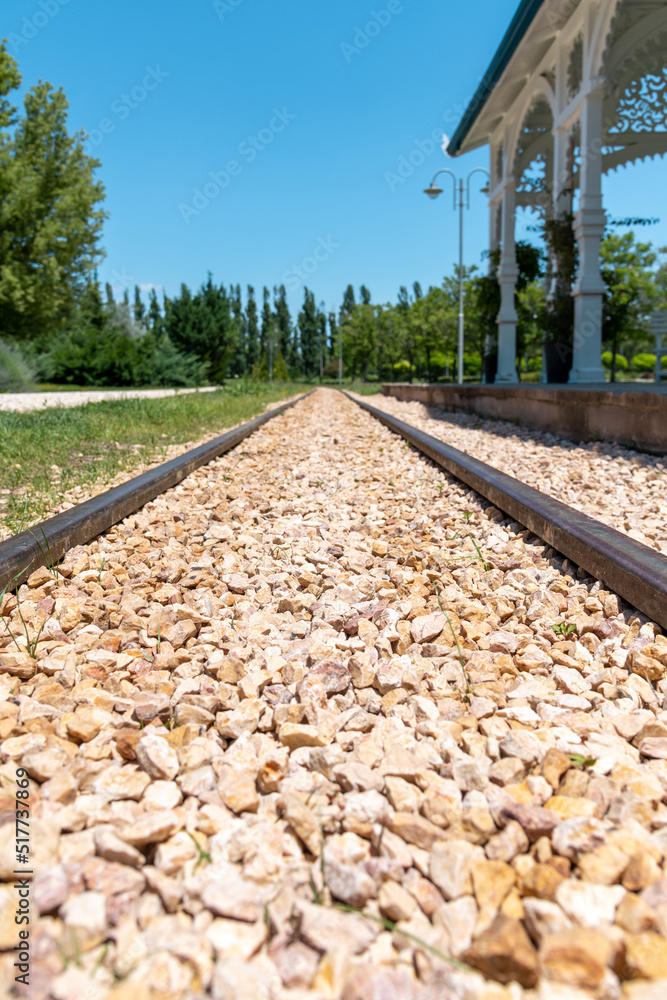 Obraz premium Railway tracks in front of the railway station on a sunny day at horizontal angle
