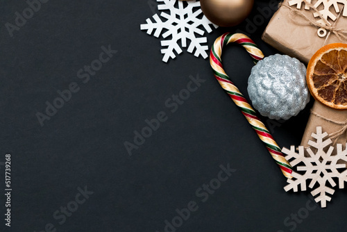 Fototapeta Naklejka Na Ścianę i Meble -  Beautiful Christmas golden silver decorations on a dark black background. Flat design, postcard, calendar, banner.