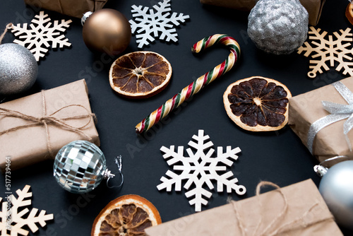 Beautiful Christmas golden silver decorations on a dark black background. Flat design, postcard, calendar, banner.