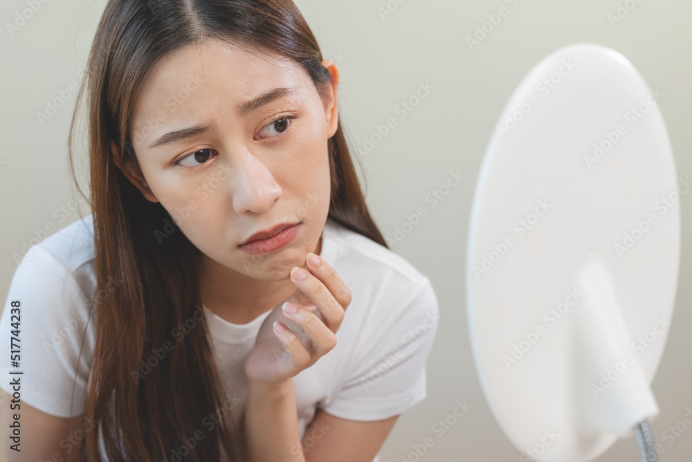 skin problem treatment. Women looking acne on her face in the mirror. skin problem treatment. Women looking acne on her face in the mirror.