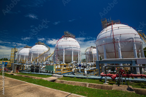 White spherical propane tanks containing fuel gas