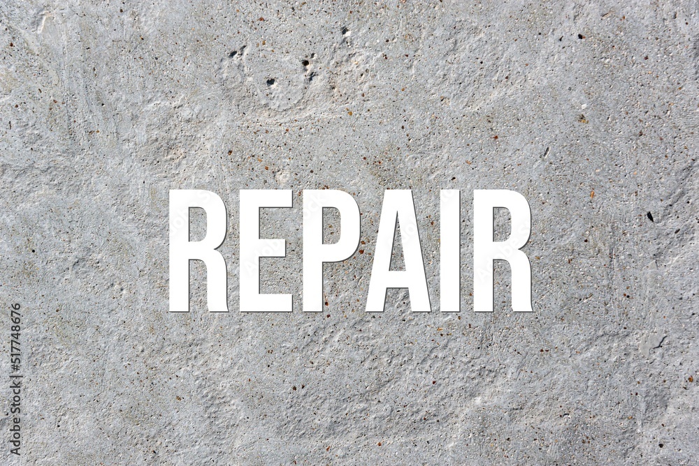 REPAIR - word on concrete background. Cement floor, wall. REPAIR - word on concrete background. Cement floor, wall.