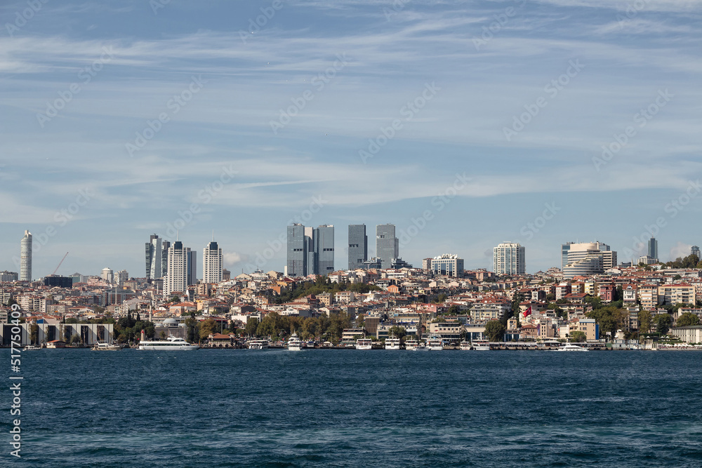 View of boats on Bosphorus, Besiktas and Levent districts on European side of Istanbul. It is a sunny summer day.