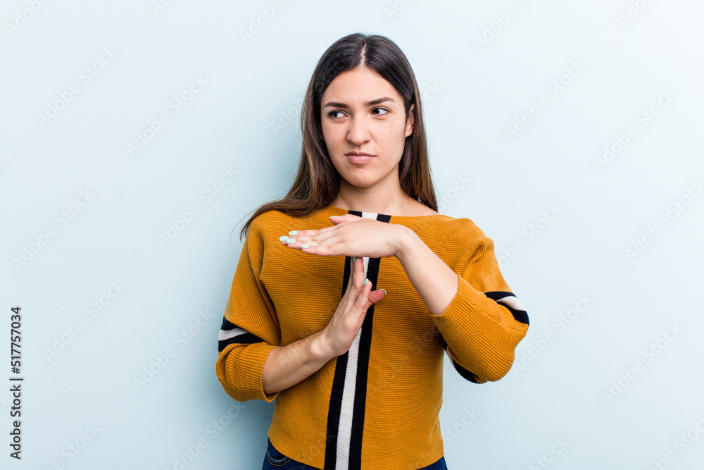 Young caucasian woman isolated on blue background showing a timeout gesture. Young caucasian woman isolated on blue background showing a timeout gesture.