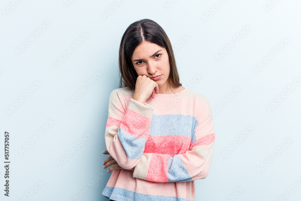 Young caucasian woman isolated on blue background tired of a repetitive task. Young caucasian woman isolated on blue background tired of a repetitive task.