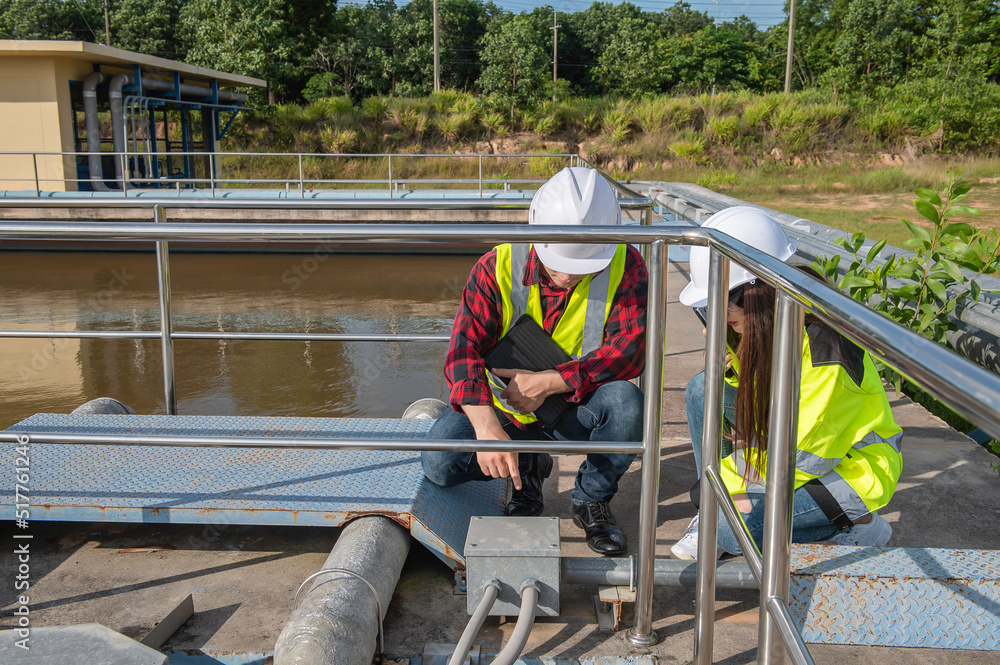 Environmental engineers work at wastewater treatment plants,Water supply engineering working at Water recycling plant for reuse,Technicians and engineers discuss work together.