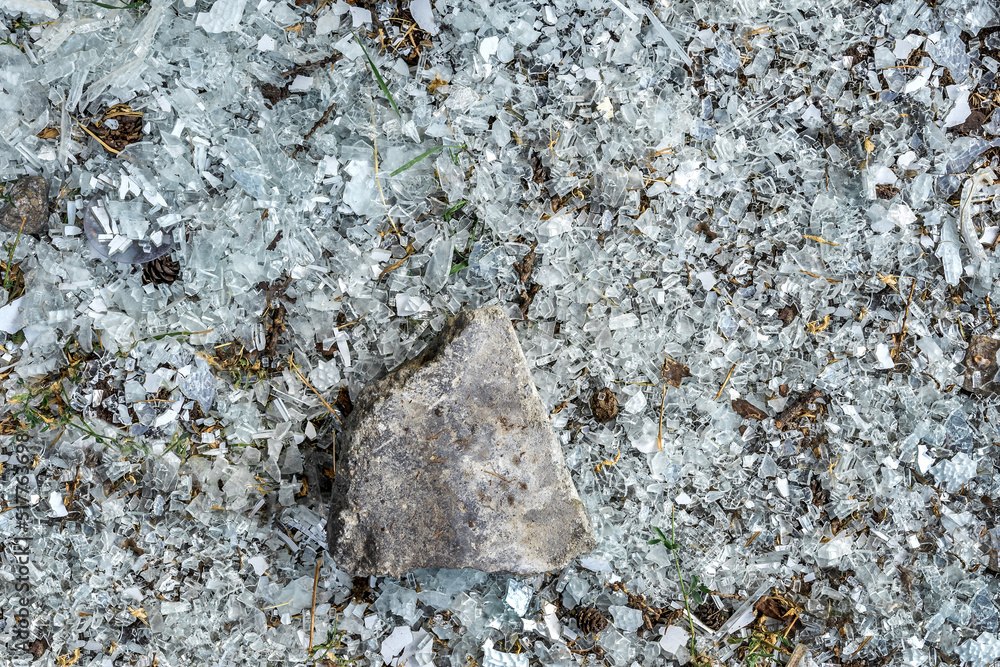 Small fragments of glass were formed due to a fallen stone. The pattern and texture of shattered glass Small fragments of glass were formed due to a fallen stone. The pattern and texture of shattered glass