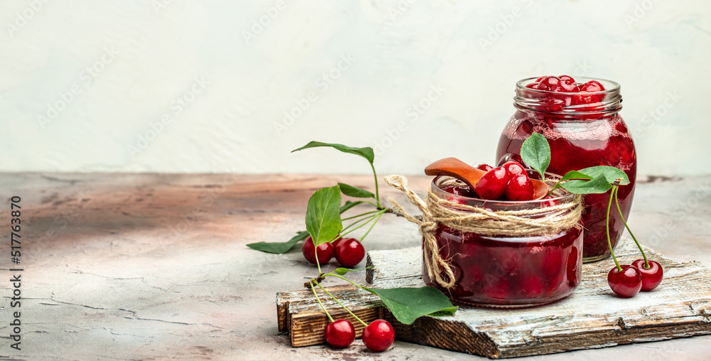 Berries cherry with syrup. Berries cherry with syrup. Canned fruit on a light background. Long banner format Berries cherry with syrup. Berries cherry with syrup. Canned fruit on a light background. Long banner format