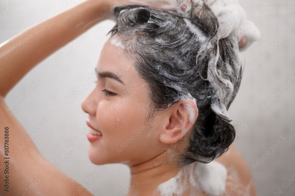 Naklejka premium Happy beautiful woman is taking a shower