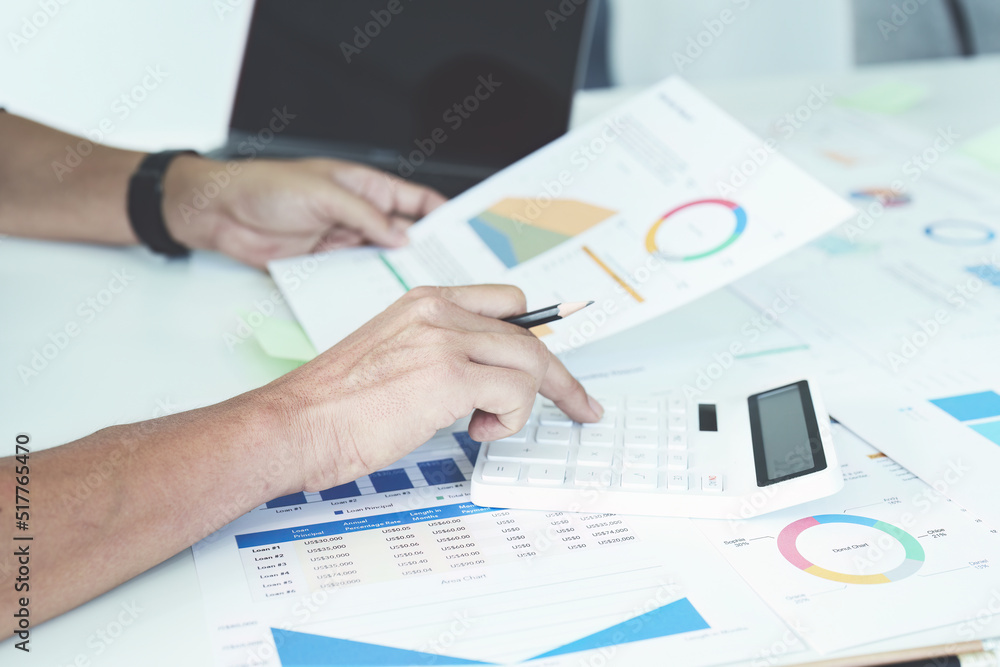 businessman hands using a calculator to check company finances and earnings and budget. calculating monthly expenses, managing budget, papers, loan documents, invoices concepts businessman hands using a calculator to check company finances and earnings and budget. calculating monthly expenses, managing budget, papers, loan documents, invoices concepts