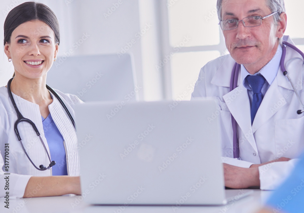 Serious medical team working in a bright office Serious medical team working in a bright office