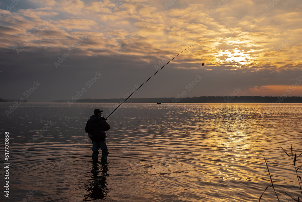 Fisherman with a fishing rod on the shore