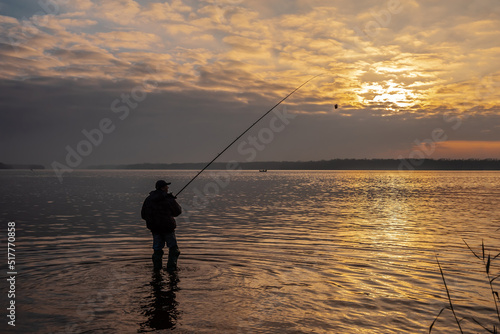 Fisherman with a fishing rod on the shore © Vitaliy