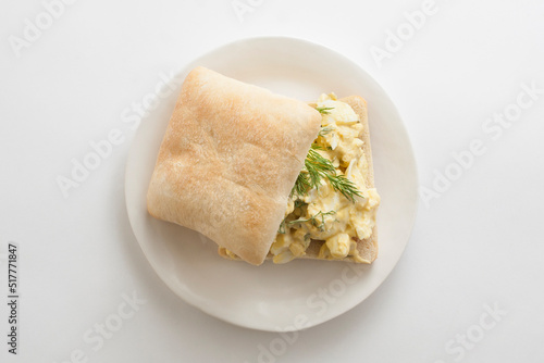 Egg Salad Sandwich on Ciabatta Roll with Fresh Dill photo